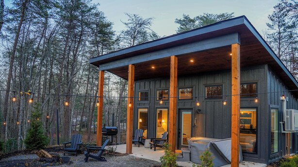 A modern cabin with a covered porch, outdoor seating, and a fireplace. - Luxurious Modern Cabin - Timber For Two (Blue Ridge)