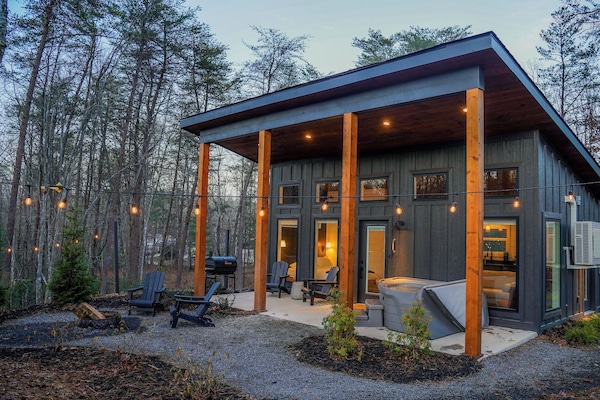 Private exterior with charcoal grill, hot tub, and fire pit.