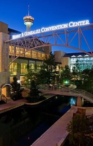 The Henry B. Gonzalez Convention Center with a prominent tower and a bridge over a water feature. - Retreat to a Brand-new Downtown Home 4BR 3BA (San Antonio)