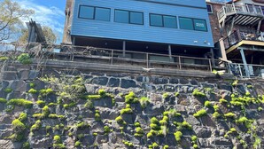 A multi-story building with a stone facade and a balcony. - Location and panoramic lake views will make for an unforgettable experience.  (Duluth)