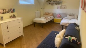 A cozy bedroom with a loft bed, a sofa, a dresser, and a shelf with stuffed animals. - 2 Bedroom Apartment in Gionghi-cappella (Gionghi-cappella)