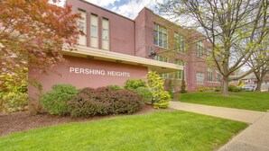 A building named Pershing Heights with a brick facade, a covered walkway, and well-maintained landscaping. - New Kensington Apt Near Parks: Pets Welcome! (New Kensington)