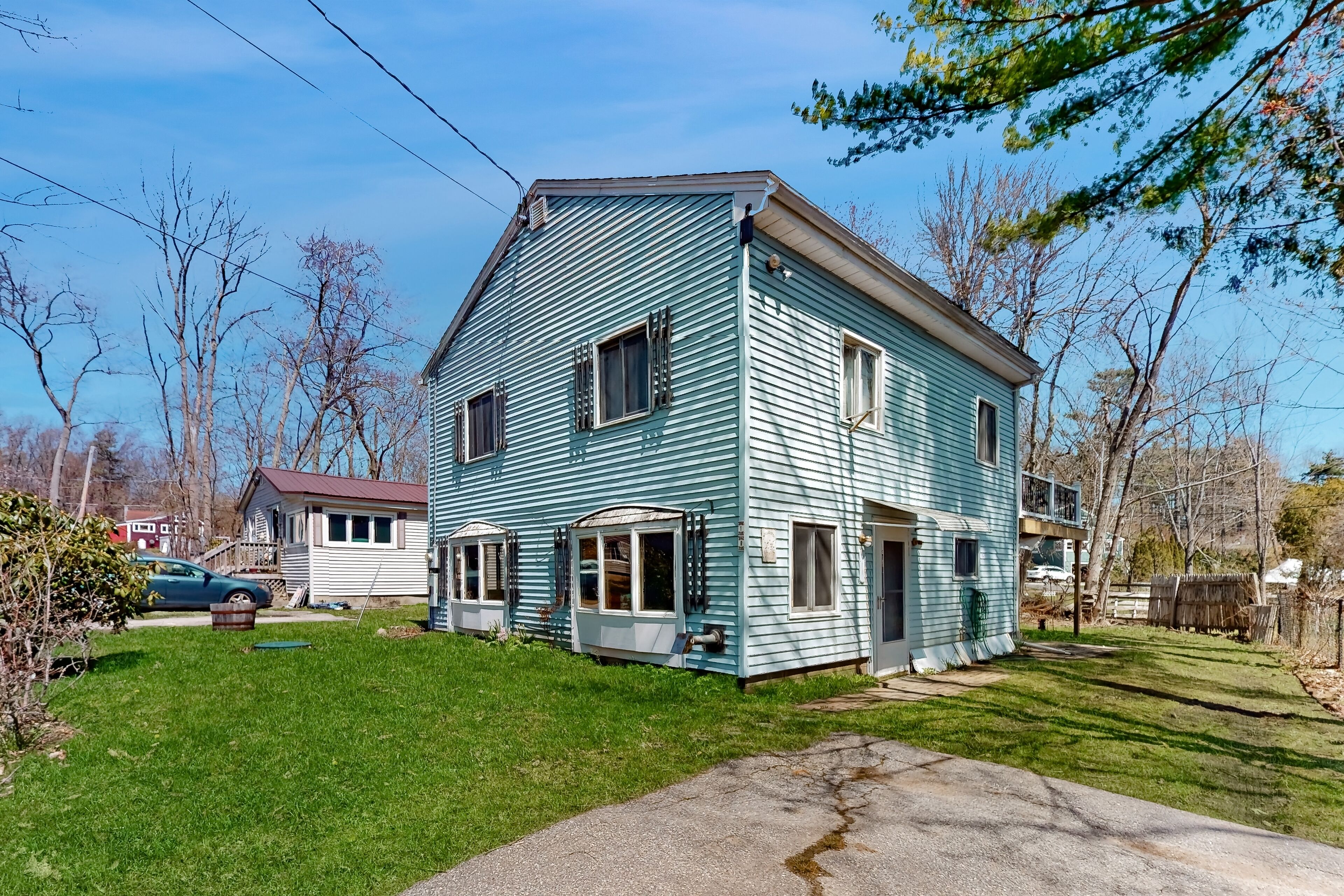 Two-story dog-friendly home with a lake view, deck, gas grill