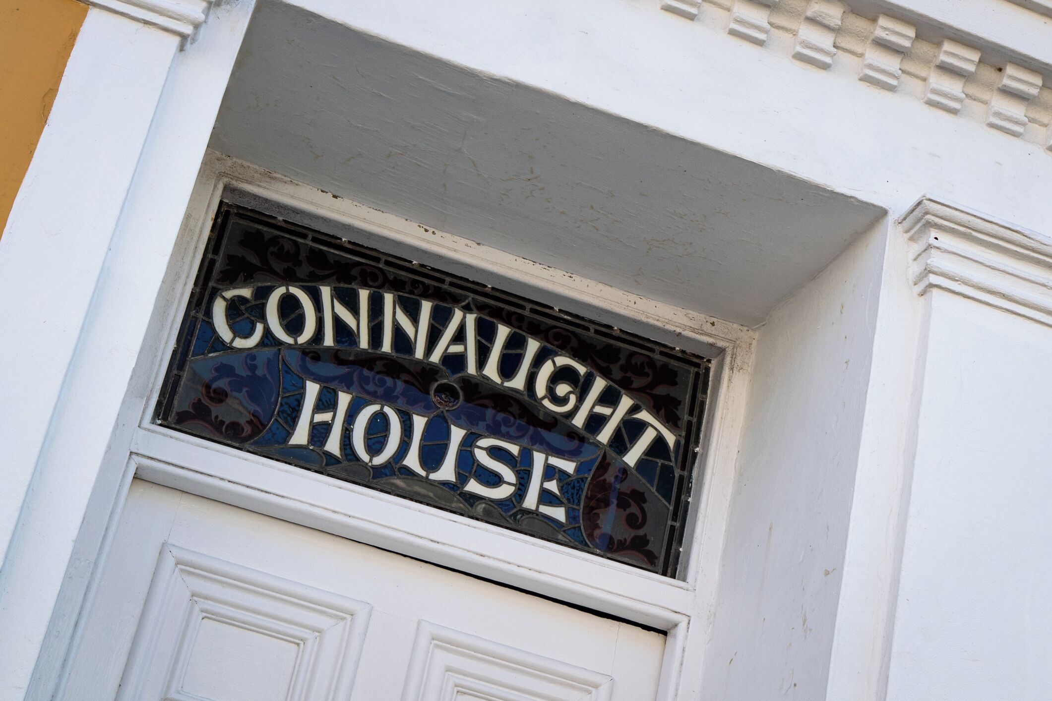 A building with a sign that reads "CONNAUGHT HOUSE".