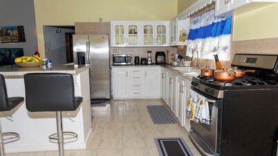 Open-concept living space cascaded in palm and fruit trees.
Family-friendly!