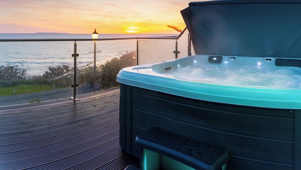 A hot tub on a balcony with a sunset view. - 3 bedroom accommodation in Woolacombe (Woolacombe)