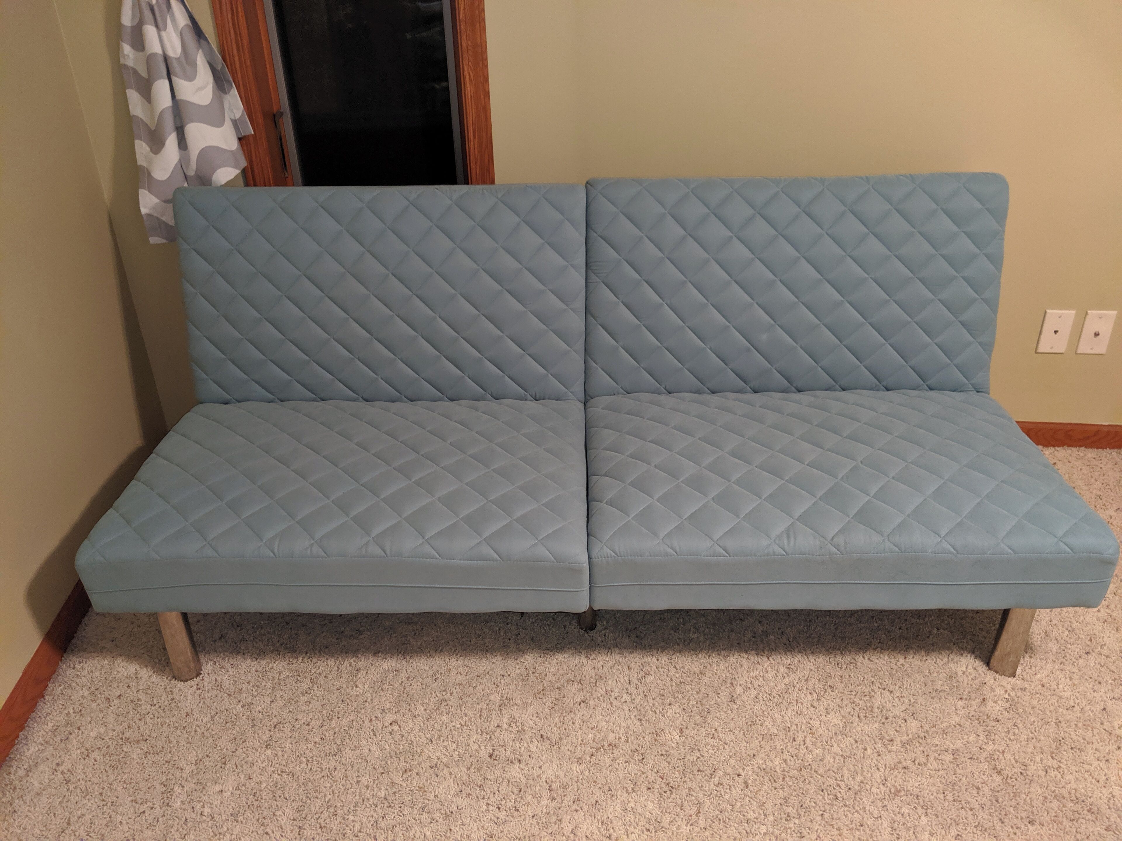 Futon couch pulls out into a bed if needed. 