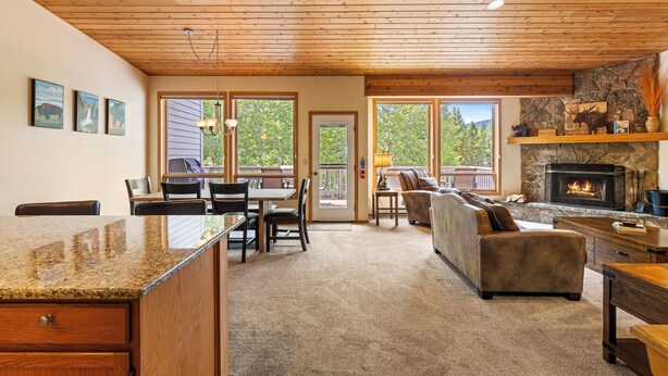 A cozy interior with a kitchen, dining area, and living room. - Woodbine Cabin | Big Sky (Big Sky)