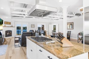 Prepare meals in the spacious kitchen with a large island and gas stove.