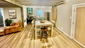 A compact living space with a dining area, kitchen, and seating area. - The Eclectic - "treehouse" - B (Bryan)