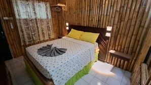 A room with a bed, a hanging light, and a window with curtains. - Barry's Rooms Negril (Negril)