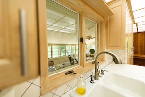 A kitchen with wooden cabinets, a white sink, and a window with blinds. - Last minute Oct booking discount-MCM mountain estate-Sleeps 18! Book now! (Menlo)