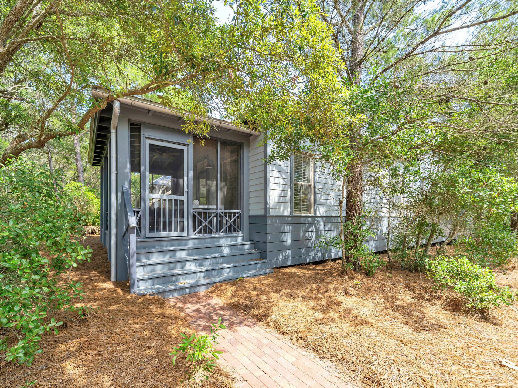 A small, single-story house with a porch and a covered entryway.