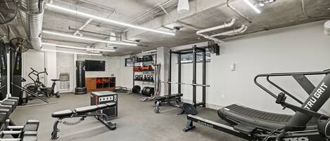 A gym with weightlifting equipment, treadmills, and exercise bikes.