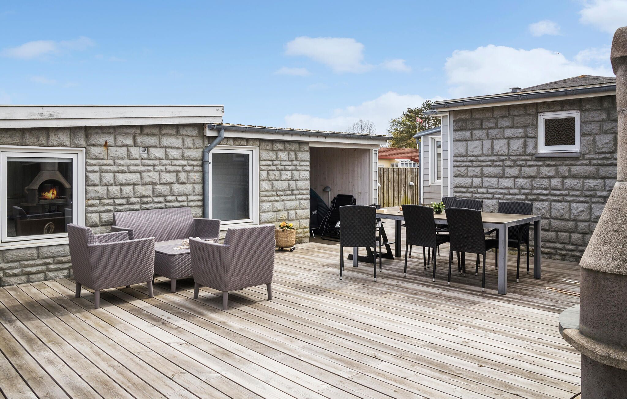 Ein Steinhaus mit Kamin, Außenbereich und einer Terrasse.