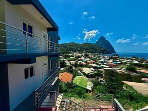 A coastal town with a prominent mountain in the background.