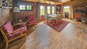 A wooden-floored dining area with a table and chairs, a red rug, and a view through large windows. - Beautiful home in Gol with kitchen (Gol)