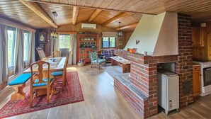 A rustic wooden interior with a dining area, a fireplace, and a cozy seating area. - Beautiful home in Gol with kitchen (Gol)
