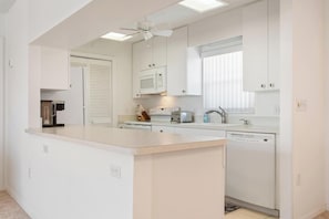 Enjoy cooking in this well-equipped kitchen with a central island, dishwasher, microwave, and toaster.