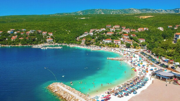 A coastal town with a beach, clear turquoise waters, and houses on a hillside. - Snjezana by Interhome (Crikvenica/Jadranovo)