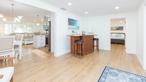 A spacious living area with a kitchen, dining area, and a bedroom. - MADEIRA BEACH RETREAT WITH HEATED POOL. (Seminole)