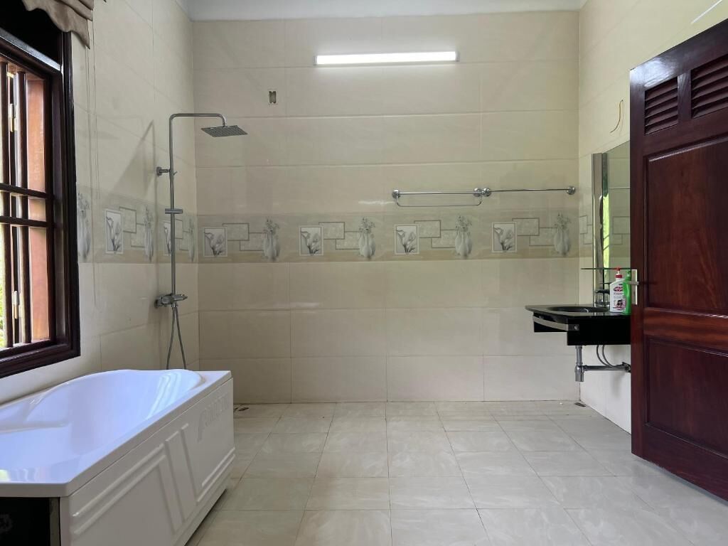 A bathroom with a bathtub, a shower, and a sink.