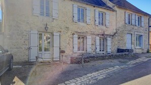 A stone building with multiple windows and doors, featuring a traditional architectural style. - 3 bedroom nice home in Saint Robert (Saint Robert)