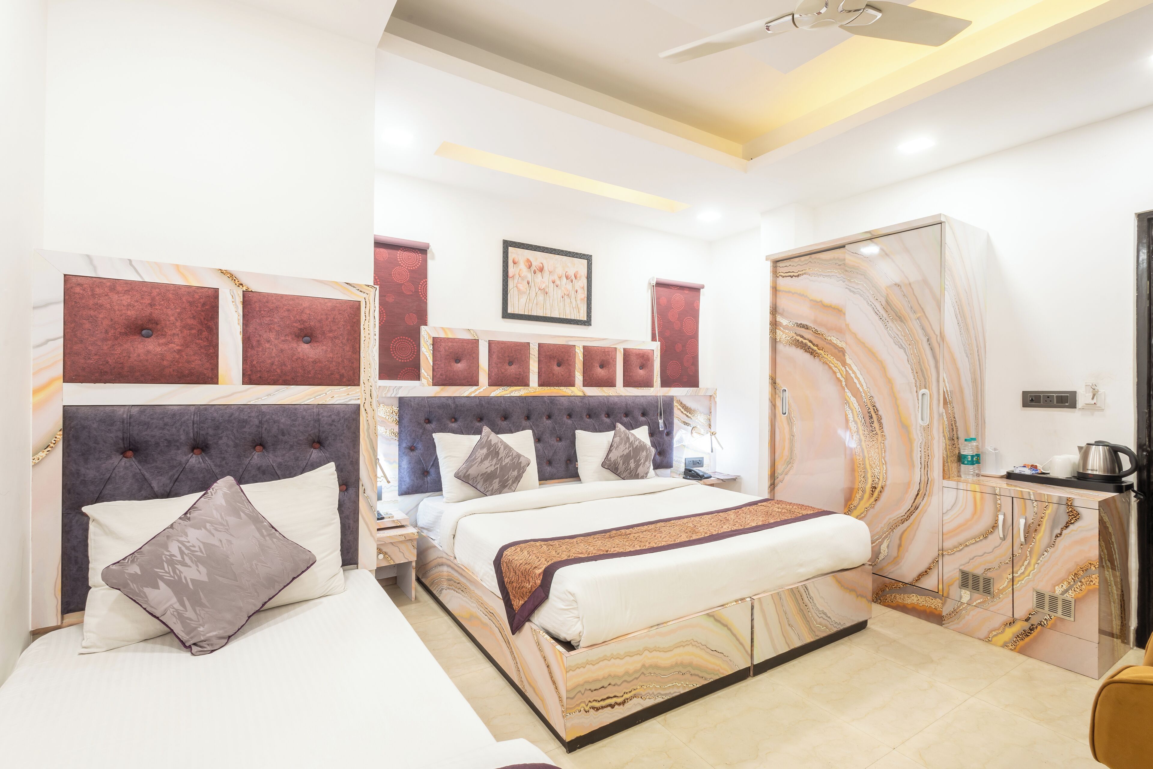 A bedroom with a bed, a headboard, a wardrobe, and a nightstand.