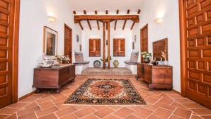 A hallway with a tiled floor, wooden doors, a bench, and a rug. - Villa with private pool, the best sea views. (Almuñécar)