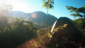 A tent in a natural setting with mountains in the background. - VerdEnergia  (Mercedes Sur)
