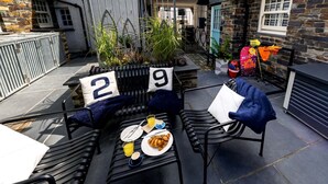 Eine Terrasse mit zwei Stühlen, einem Tisch mit Frühstück und Schildern mit der Aufschrift 2 und 9.