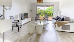 A modern living room with a sofa, chairs, a coffee table, and a TV. - Les Balcons d'Eze by Interhome (Eze)