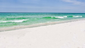 A beach with clear turquoise water and white sand.
