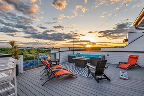 A rooftop terrace with outdoor seating, a pool table, and a sunset view. - Nashville music-themed house with hot tub, sleeps 12 for family trips (Nashville)