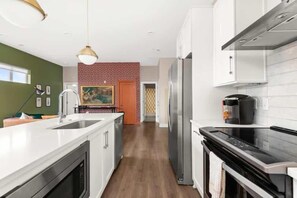Fridge, microwave, oven, stovetop - Bright 2 Bed, Garage Parking, Walk to Park, Vandy Single Story Modern and Stylish Condo in Secure Building, 10 Mins to Broadway and 12 South, 24 Hr Hospitality (Nashville)