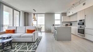 A modern apartment with a living room, kitchen, and dining area. - Walk to Hollywood Beach: Upscale 16th-Floor Condo (Hollywood)