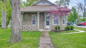 A stone house with a front porch, a small garden, and a visible mailbox. - Pet-Friendly Pacific Cottage Near Purina Farms! (Pacific)