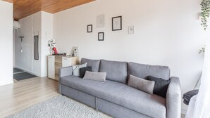 A modern living room with a grey sofa, a coffee machine, and framed pictures on the wall. - Nice studio 4 pers near the slopes (Orcières)