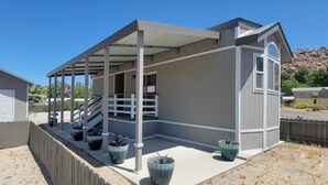 A single-story building with a covered porch, a garage, and a small attached structure. - Desert Haven Resort Perfect for Active Couples Seeking Adventure (Jacumba Hot Springs)