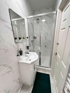 Shower, towels, soap, toilet paper