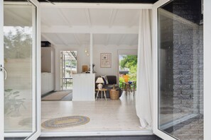 A modern interior with a sofa, a small table, a lamp, and a basket.