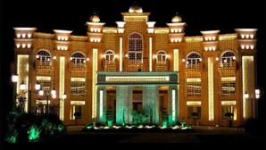 A large, ornate building with multiple arched windows and a central entrance. - Devrath By Big Bite Resort (Meerut)