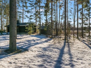 A cabin surrounded by a forest with snow on the ground. - Valkjärvi 2 by Interhome (Iitti)