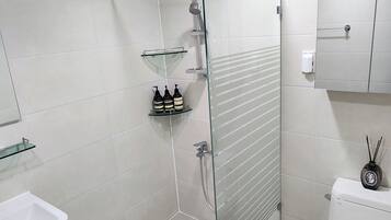 Shower, hair dryer, slippers, towels