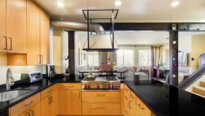 A compact kitchen with a gas stove, a coffee maker, and a toaster. - Two  Bedroom, Two Newly Renovated Bathrooms, Deck (San Francisco)