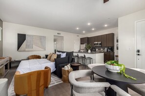 A modern apartment with a living area, kitchen, and dining space. - Macallister Luxe 1008 | Close to Golf |Heated Pool (Scottsdale)