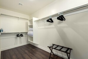 A hotel room with a walk-in closet, a wooden floor, and a metal rack with shoes. - Macallister 2007|Close2Golf|BBQ|Heated Pool|Views (Scottsdale)