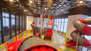 A play area with slides and a colorful floor.