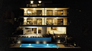 A multi-story modern house with a swimming pool, balconies, and large windows. - Athens Riviera Suites (Saronikos)