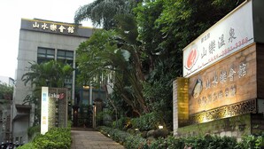 Un sendero que conduce a un edificio con indicaciones de un restaurante y un hotel.